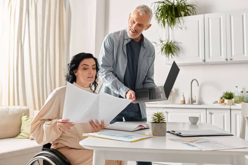 Stock Photo Disabled Woman Wheelchair Her Husband Collaborate Paperwork Kitchen Home